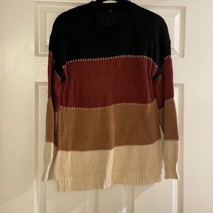 Black, burgundy, brown, cream, with gold sweater.